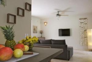 a living room with a table with a bowl of fruit at Escalonia 2 in Las Terrenas
