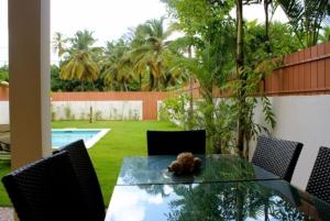 a glass table with a teddy bear sitting on top of it at Escalonia 2 in Las Terrenas +6 photos