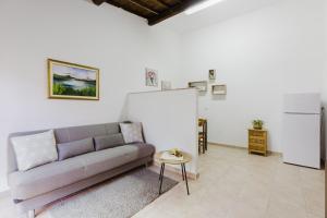 a living room with a couch and a table at Il Corbezzolo Apartment in Palmas Arborea