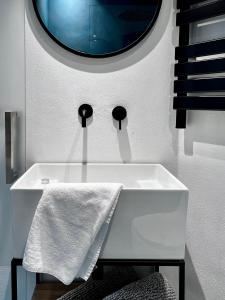 a bathroom with a white sink and a mirror at Loft G Hospitality in Milan +61 photos