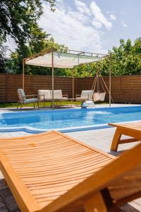 a swimming pool with a swing and an umbrella at Panorama Górska Wisła Resort & SPA in Wisła