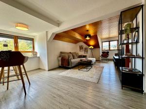 a living room with a couch and a table at Ferienwohnung Olymp (2,5 Zimmer) in Eggingen