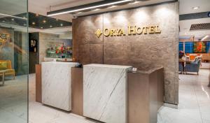 a lobby with a hotel sign on a wall at Orya Hotel in Istanbul