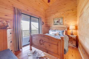 a bedroom with a bed and a large window at Hilltop Concan Cabin with Garner State Park Views! in Concan +25 photos