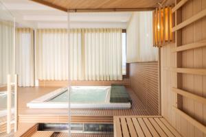 a hot tub in the middle of a room at Paolimura Resort , Apartment & Spa in Aci Catena