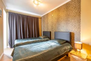 a bedroom with two beds next to a window at Appartement centrum 1 in Ostend