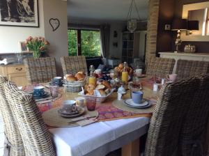 a dining room table with food on it at B&B au 27 in Stavelot