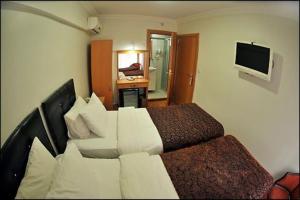 una camera d'albergo con letto e TV di Palace Point Hotel a Istanbul