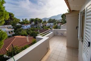 a balcony with a view of a city at 'Alexander' Seaside House With View In Nea Makri in Nea Makri