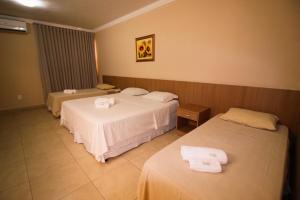 Ένα ή περισσότερα κρεβάτια σε δωμάτιο στο Hotel Regina Muriaé