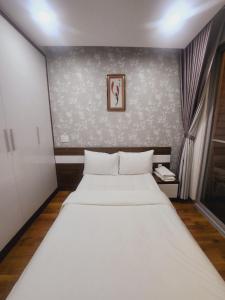 a bedroom with a large white bed in a room at Scenic Valley 2 in Ho Chi Minh City