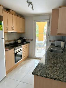 a kitchen with a sink and a counter top at Beautiful 3 bed, 2 bath modern apartment in Los Alcázares