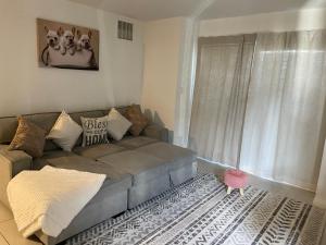 a living room with a couch and a window at Fabulous downtown experience 3 mins away in Las Vegas