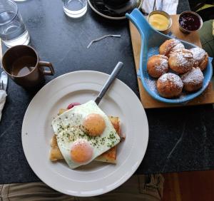 a plate of food with eggs and pastries on a table at Commodore Hotel in Astoria, Oregon