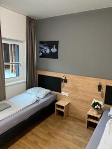 a hotel room with a bed and a window at Firstsleep Ebersberg in Ebersberg