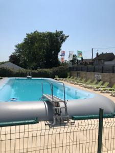 a large swimming pool with a chair next to it at mobil home o'hara in Poilly-lez-Gien