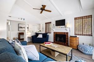 a living room with a blue couch and a fireplace at Beachwalk 158 in Hilton Head Island