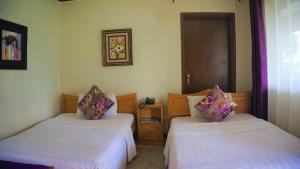 A bed or beds in a room at ATACO COUNTRY RESORT
