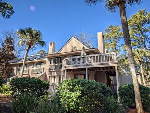 a house with palm trees in front of it at Beachwalk 158 in Hilton Head Island