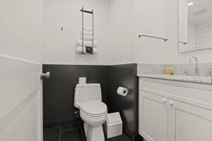 a bathroom with a white toilet and a sink at Stay Rafa At 2000 Spruce in Philadelphia
