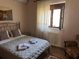 a bedroom with a bed with towels on it at Kiwi Traditional House in Litochoro