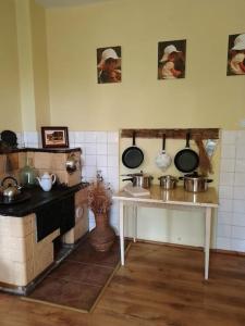 a kitchen with pots and pans on the wall at Studniska Horse Centrum in Studniska