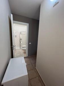 a bathroom with a white bench and a toilet at Casa Duilia centro storico in Padenghe sul Garda +15 photos