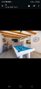 a ping pong table in a living room at Villa Ivan in Pridraga
