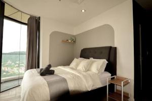 a bedroom with a large bed with a teddy bear on it at KL Marriot Empress Suite Infinity View Apartment- Self Check/In in Petaling Jaya