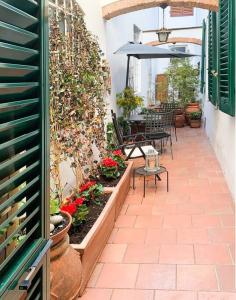 a patio with a table and chairs and an umbrella at Your place in San Frediano in Florence