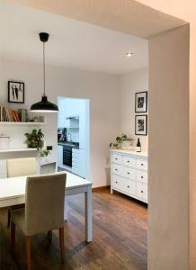 a kitchen with a white table and a dining room at Your place in San Frediano in Florence