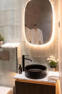 a bathroom with a sink and a mirror at SAINT-LOUIS APARTMENT - LUXURY HIGH END RENOVATED Apartment - HEART OF LE MARAIS - HOTEL DE VILLE in Paris