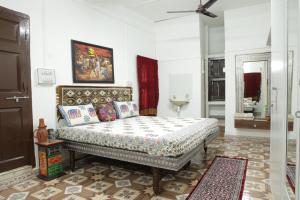a bedroom with a bed and a ceiling fan at Prag View Heritage Homestay in Bhuj