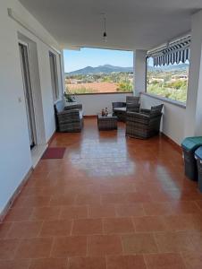 a living room with couches and a large window at Casa Pipere in Santa Lucia