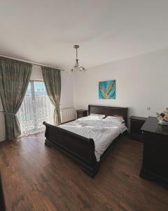a bedroom with a large bed and a large window at Casa Mara in Cristian