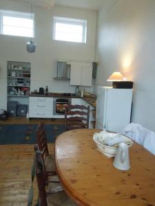 a kitchen with a wooden table with chairs and a dining room at Durrus in Durrus