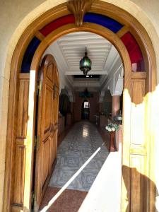 an archway leading into a building with a hallway at Riad malak in Marrakesh