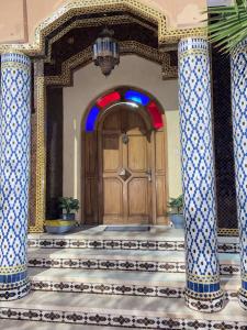 an entrance to a building with a wooden door at Riad malak in Marrakesh
