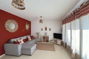 a living room with a couch and a television at Casa Dorada Puerto del Carmen in Puerto del Carmen