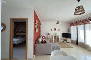 a living room with a couch and a bed at Casa Dorada Puerto del Carmen in Puerto del Carmen