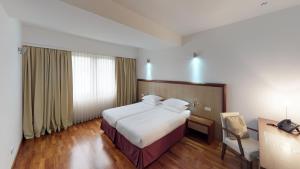 a hotel room with a bed and a desk at Luxury Skopje Apartments Premium in Skopje