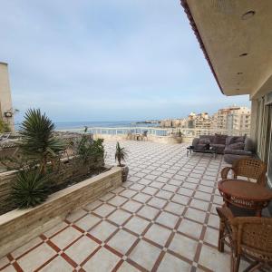a patio with a view of the ocean at برج الصفوه القبطان محمد يسرى للعائلات family only in Alexandria