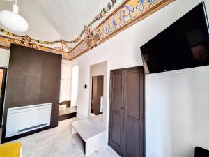 a living room with a flat screen tv on a wall at Intrecci B&B in Terlizzi