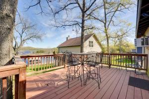 um deque de madeira com uma mesa e cadeiras em Lakeside Reeds Spring Home with Pool Access and Deck! em Reeds Spring
