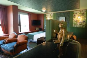 a hotel room with a monkey sitting on a table at Hotel Eco Boutique Bidasoa in Santiago