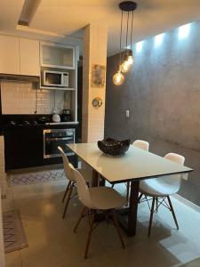 a kitchen with a table and chairs in a kitchen at Lindo apartamento em Copacabana in Rio de Janeiro