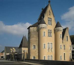 a large building with a tower at Maison charmante à La Flèche avec jardin et parking privé in La Flèche