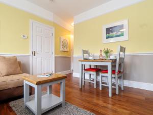 a living room with a table and chairs and a couch at Flat 1 Niles Place in Padstow