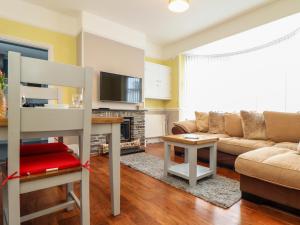 a living room with a couch and a table at Flat 1 Niles Place in Padstow