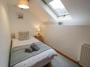a bedroom with a bed and a skylight at Graig Las The Stables in Oswestry